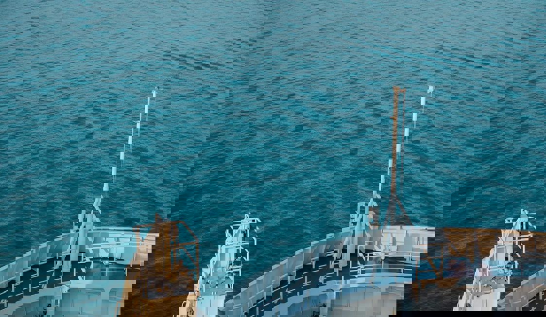 Aft of a ferry seen over open sea from an aerial view on the left side in the image Hallbar Energi.