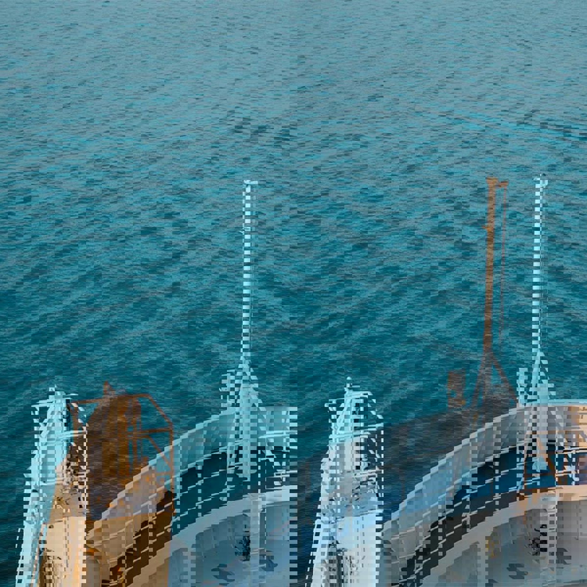 Aft of a ferry seen over open sea from an aerial view on the left side in the image Hallbar Energi.