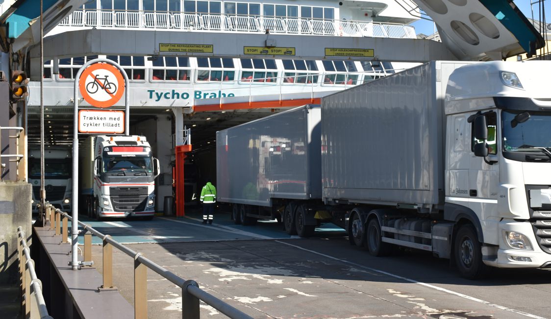 Trucks boarding the Molslinjen ferry Tycho Brahe, viewed from the side at the port's departure area.