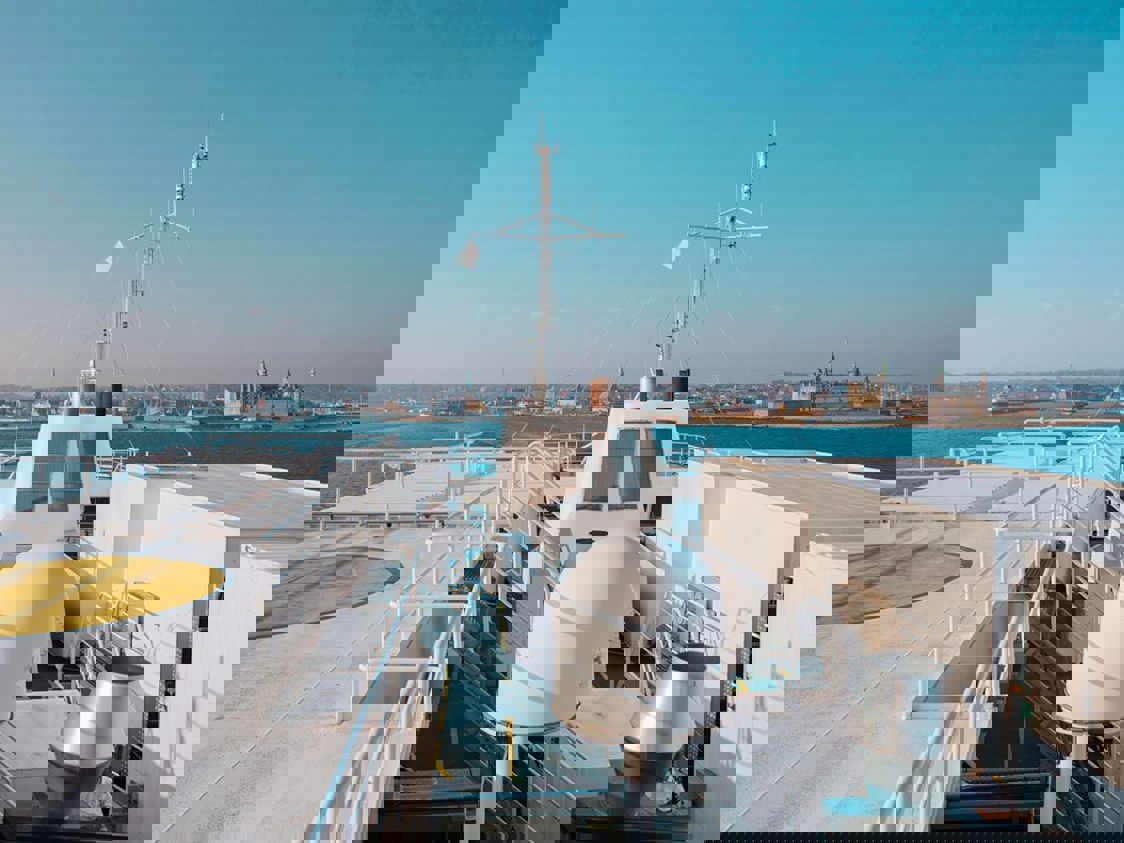 Top of the ferry visible with water on the horizon and a completely blue sky.