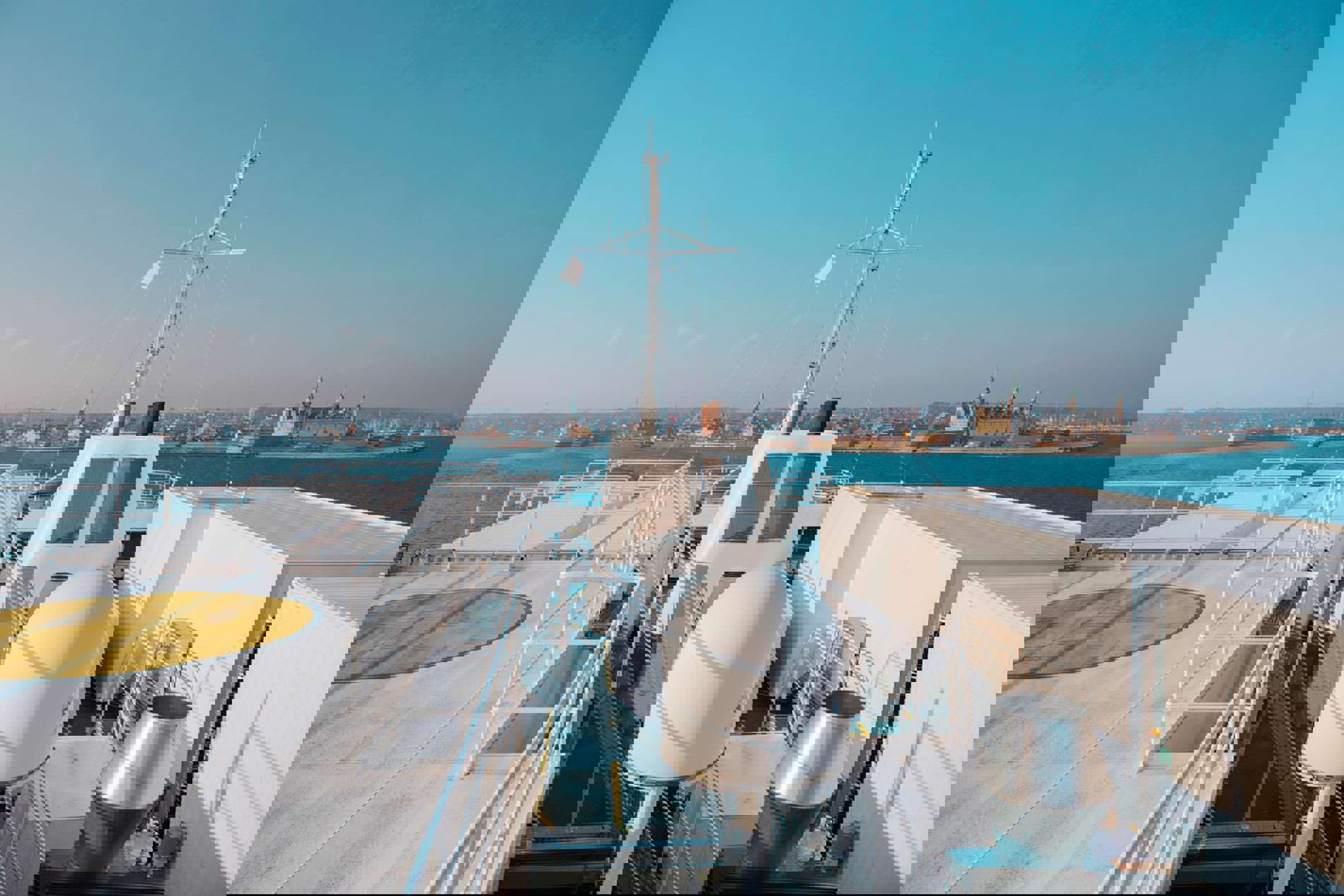 Top of the ferry visible with water on the horizon and a completely blue sky.