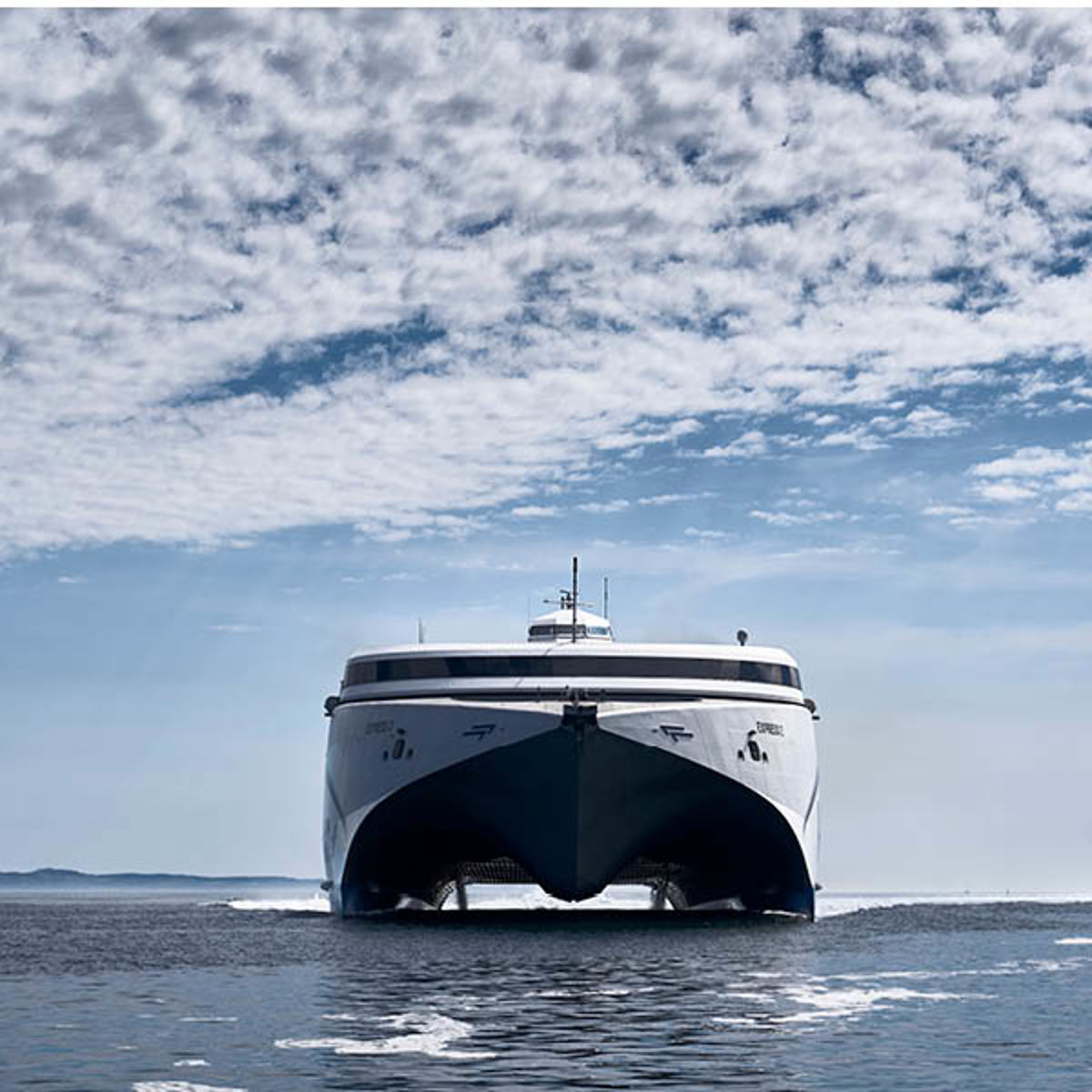 Molslinjen færge i bevægelse på havet under en skyet himmel, set forfra i perspektiv.