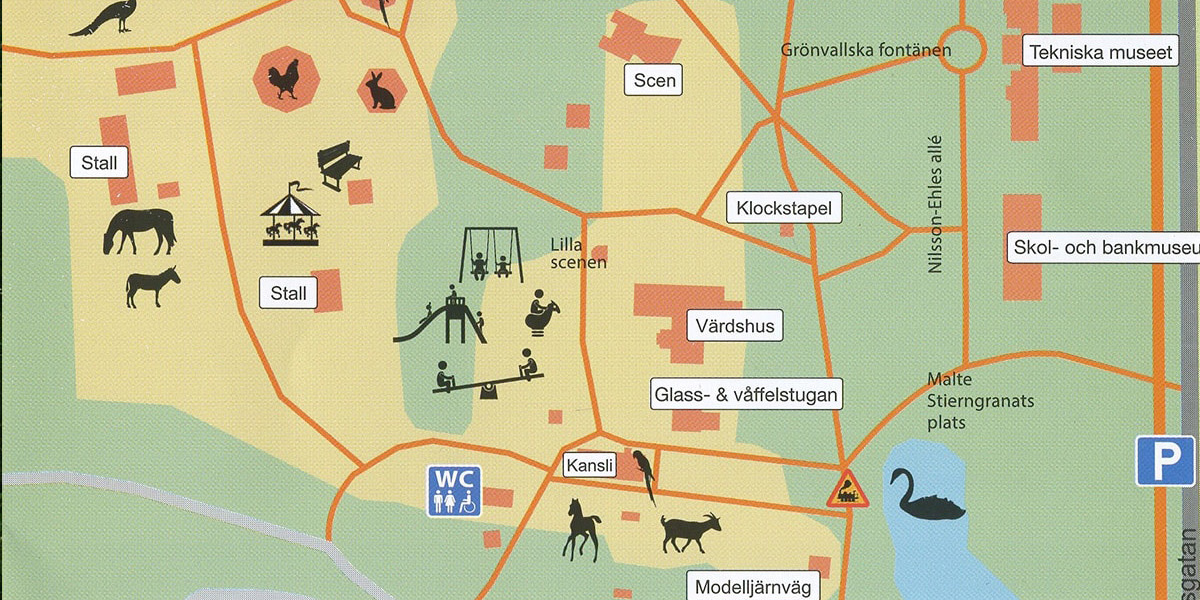 Kort over park med stalde, legeplads og scener, markeret med ikoner for dyr, legeplads og spisesteder.